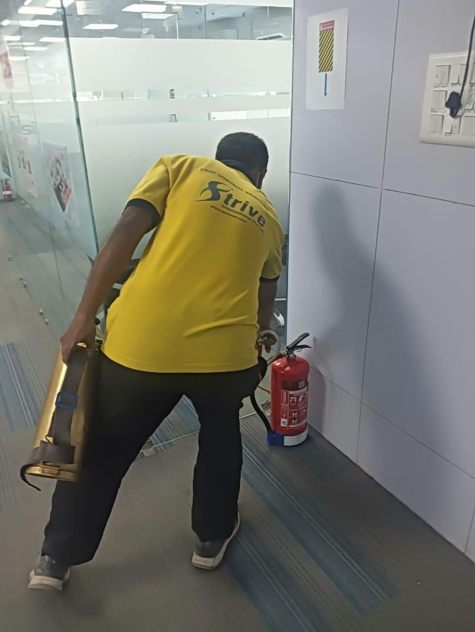 Strive International technician treating an office perimeter area