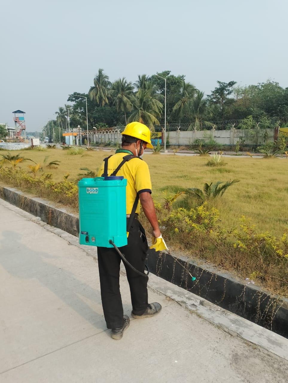 Strive International technician treating landscaped grounds around a commercial site